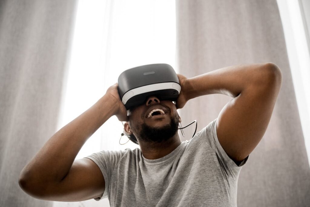 Man in Gray Crew Neck T-shirt Wearing White and Black Vr Goggles